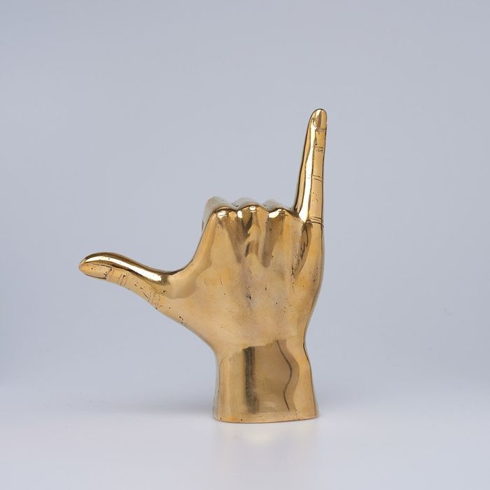 Shaka-handgebaar in gepolijst messing
